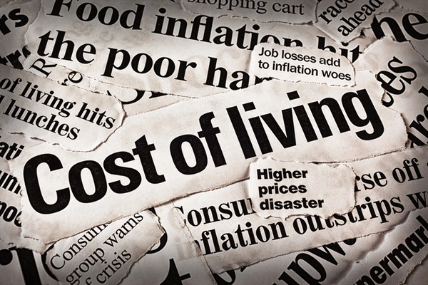 A collage of newspaper headlines related to economic issues, prominently featuring the phrase 'Cost of living' alongside headlines about inflation, job losses, and higher prices.